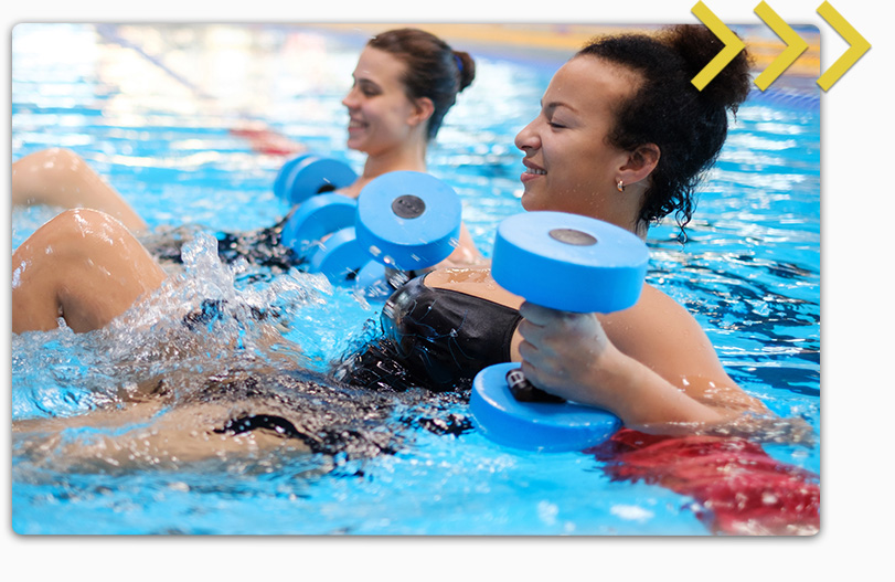 Women holding water weights and doing pool aerobics