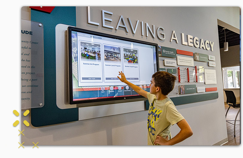 Boy looking at interactive display of Lincoln Community Center history